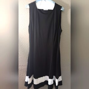 Black A line dress with white trim on the bottom